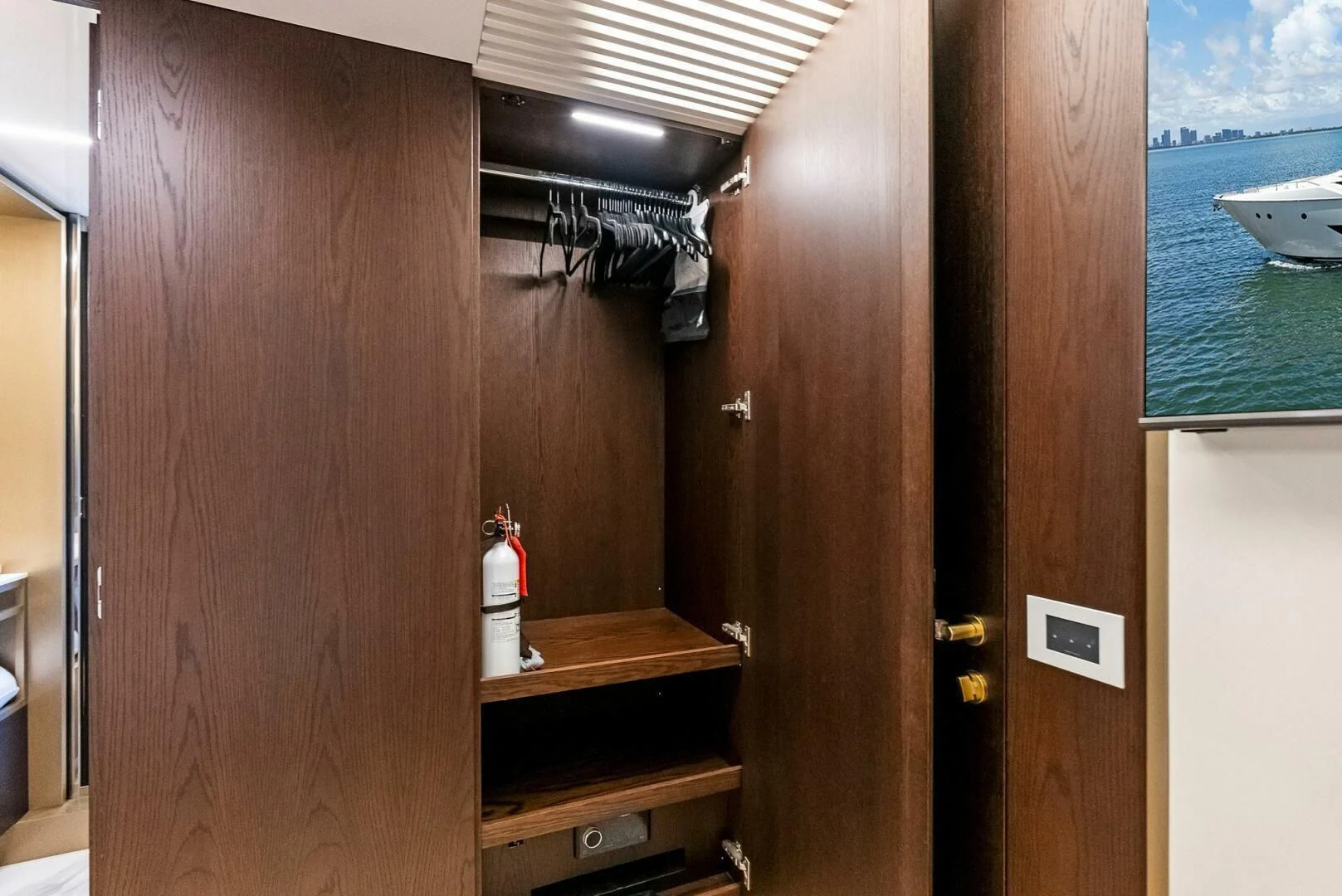 a wood cabinet with a door and a window aboard INEA Yacht for Sale