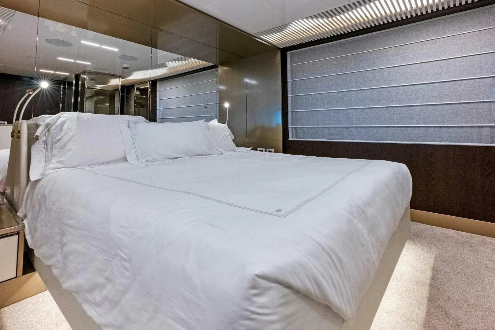 a bed with white sheets aboard INEA Yacht for Sale