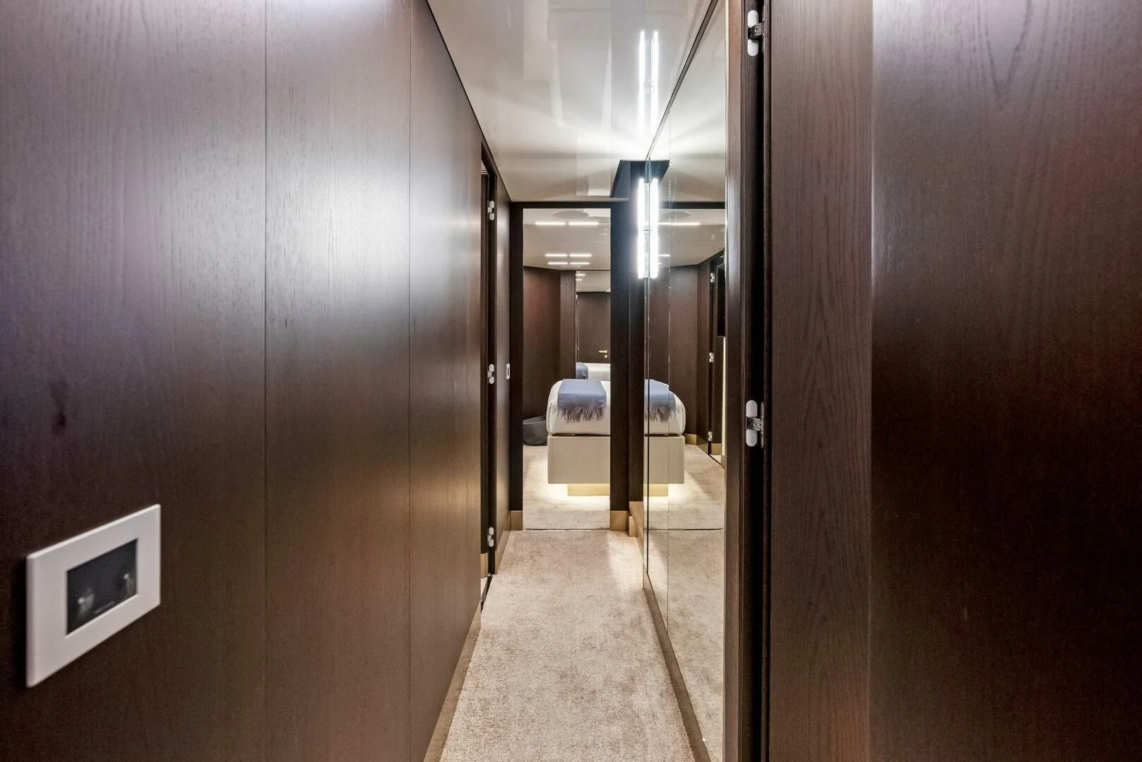 a hallway with a door and a bed in it aboard INEA Yacht for Sale