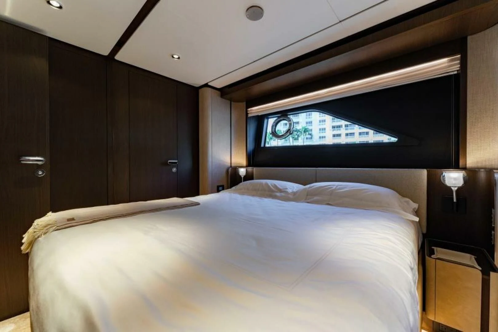 a bed with a white bed spread aboard INEA Yacht for Sale