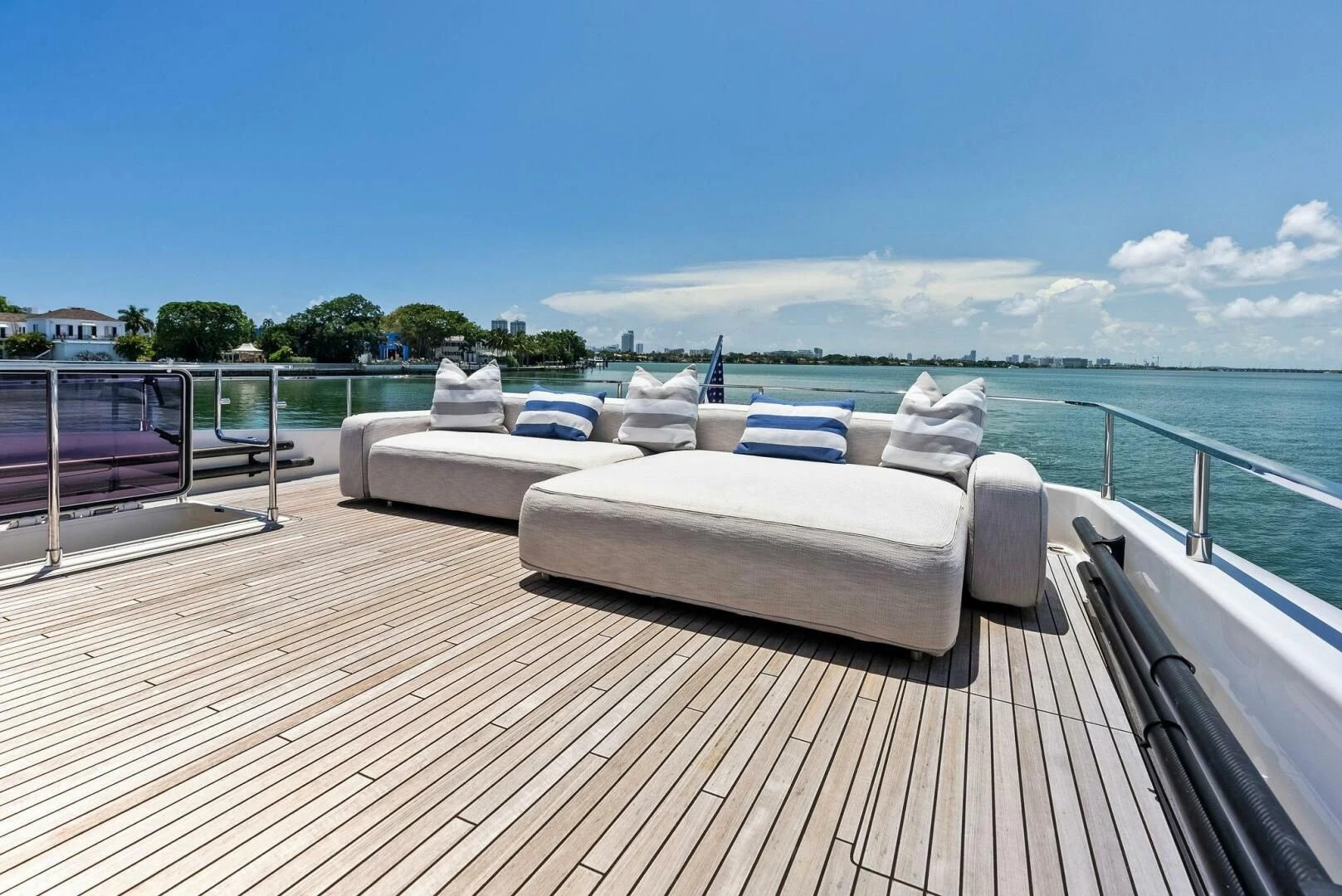 a deck with a view of the ocean and a beach aboard INEA Yacht for Sale