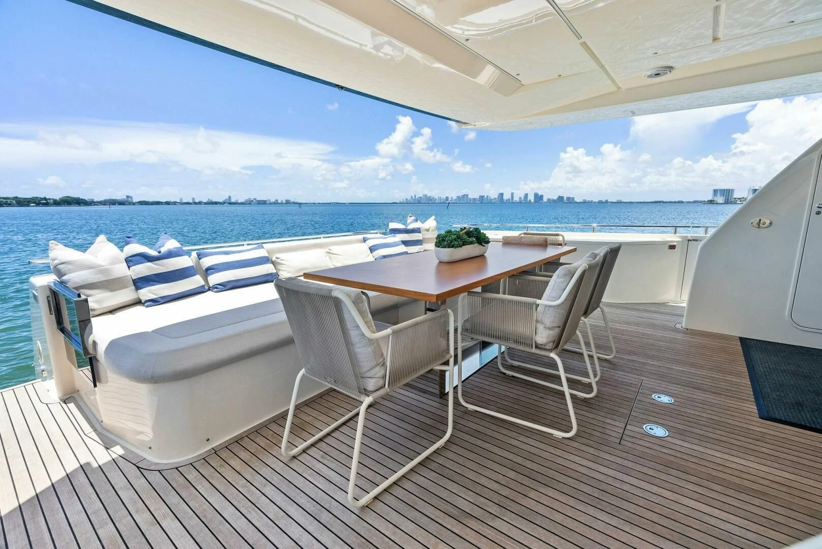 a table and chairs on a deck overlooking the ocean aboard INEA Yacht for Sale