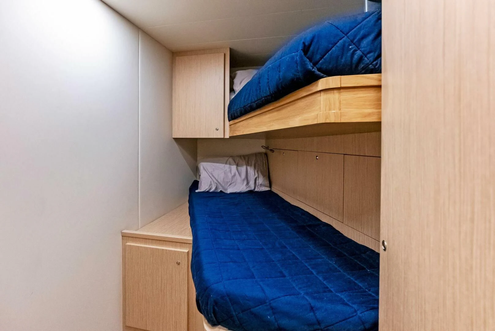 a bed with a blue sheet aboard INEA Yacht for Sale