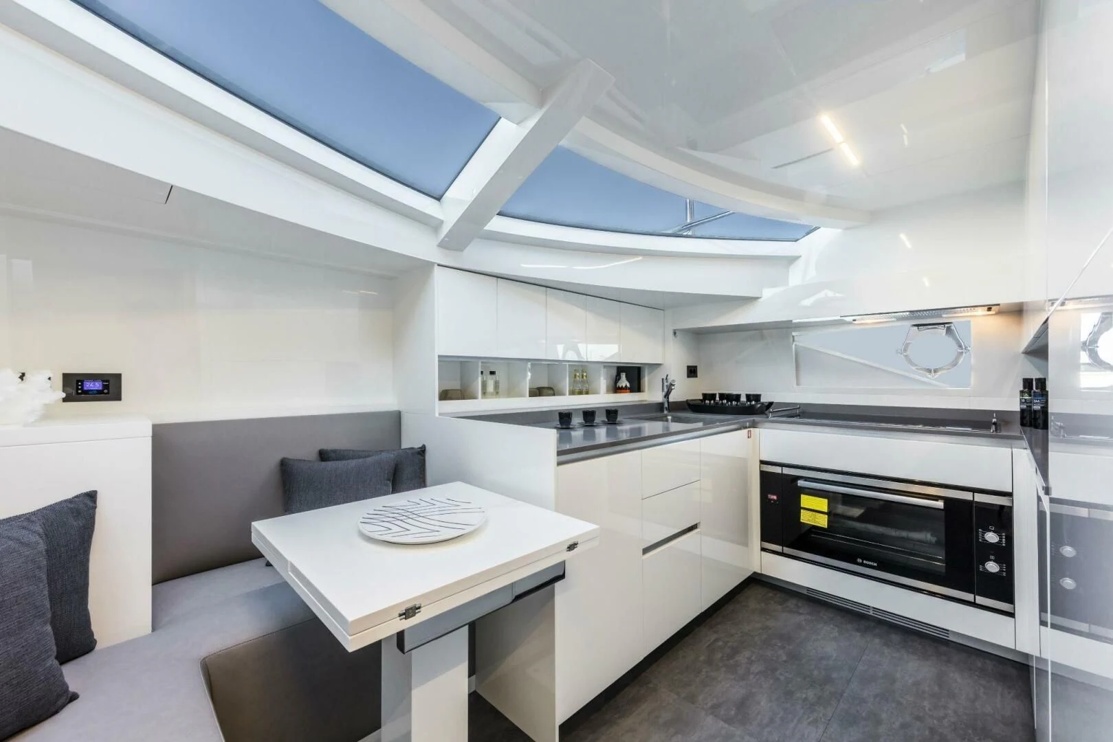 a kitchen with a table and chairs aboard INEA Yacht for Sale