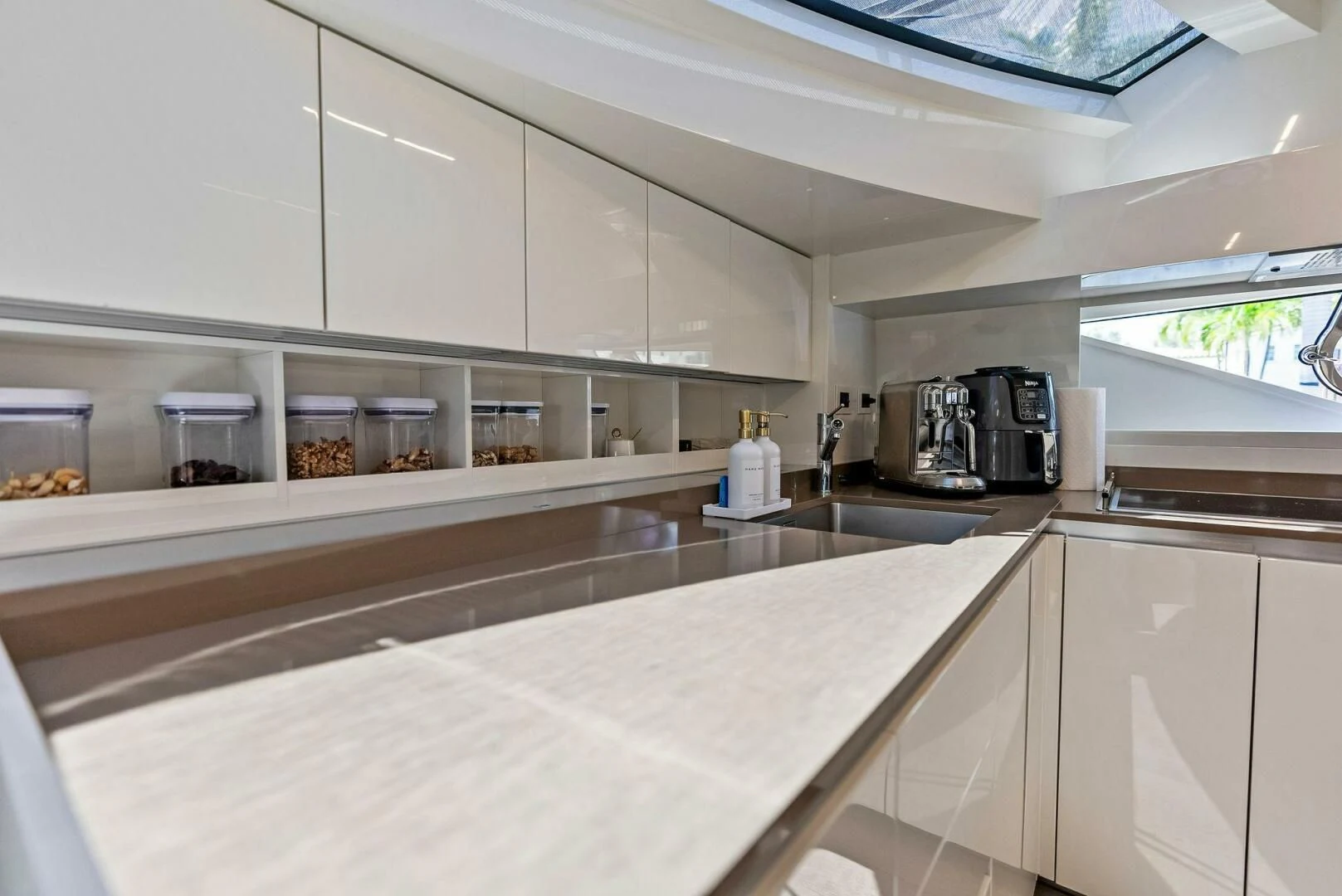 a kitchen with white cabinets aboard INEA Yacht for Sale