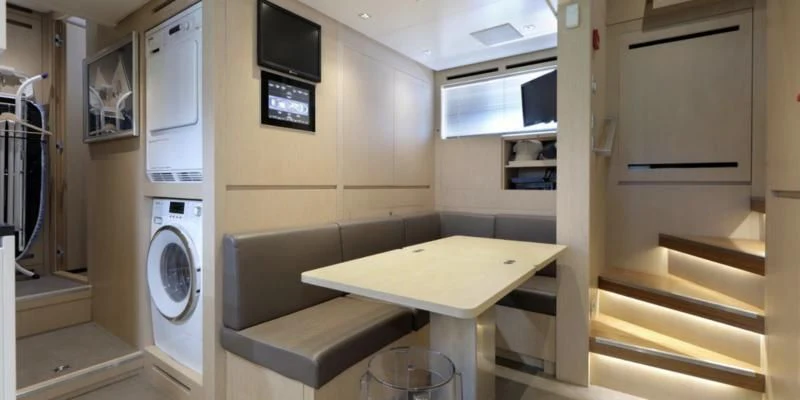 a room with a table and a tv aboard COBANA Yacht for Sale