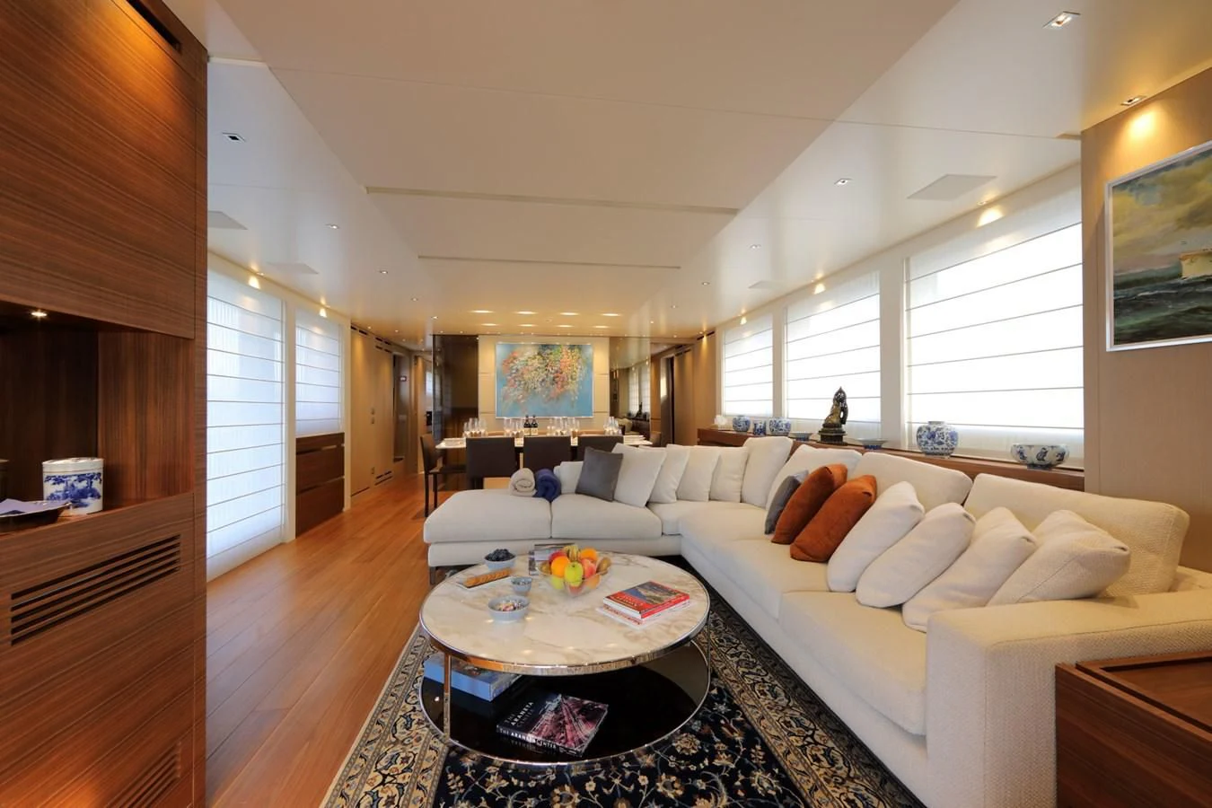 a living room with a large white couch and a large window aboard COBANA Yacht for Sale