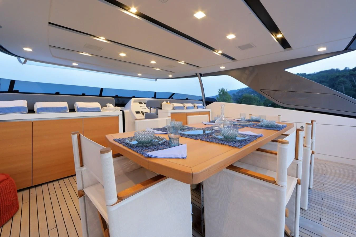 a table with chairs and a bench aboard COBANA Yacht for Sale