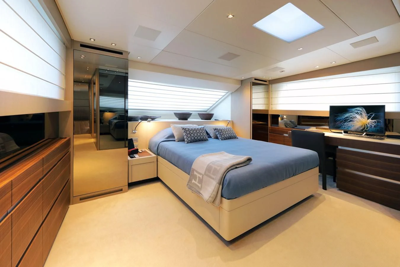 a bedroom with a bed and a desk aboard COBANA Yacht for Sale