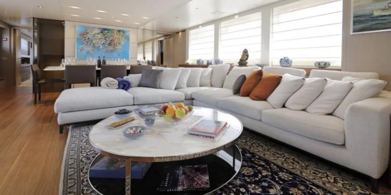a living room with a couch and a coffee table aboard COBANA Yacht for Sale