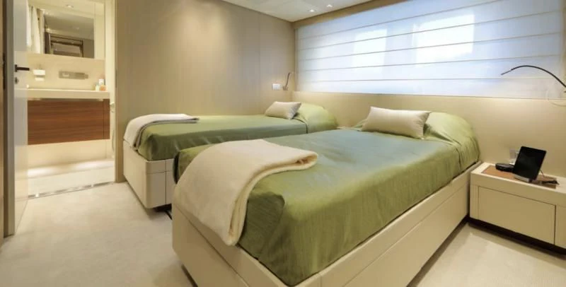 a room with a bed and a desk aboard COBANA Yacht for Sale