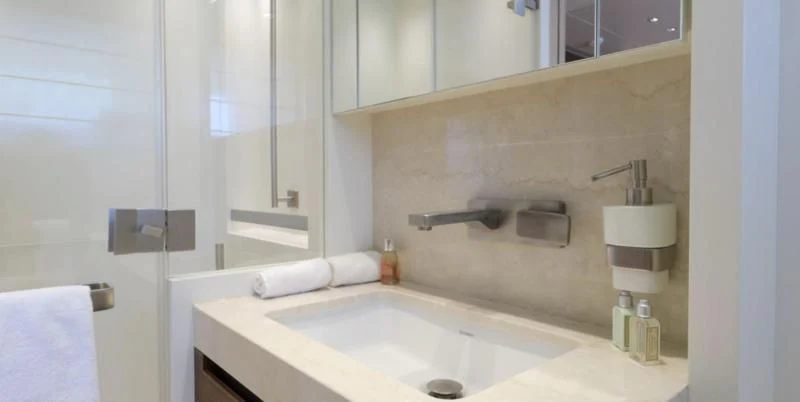 a bathroom with a sink and mirror aboard COBANA Yacht for Sale