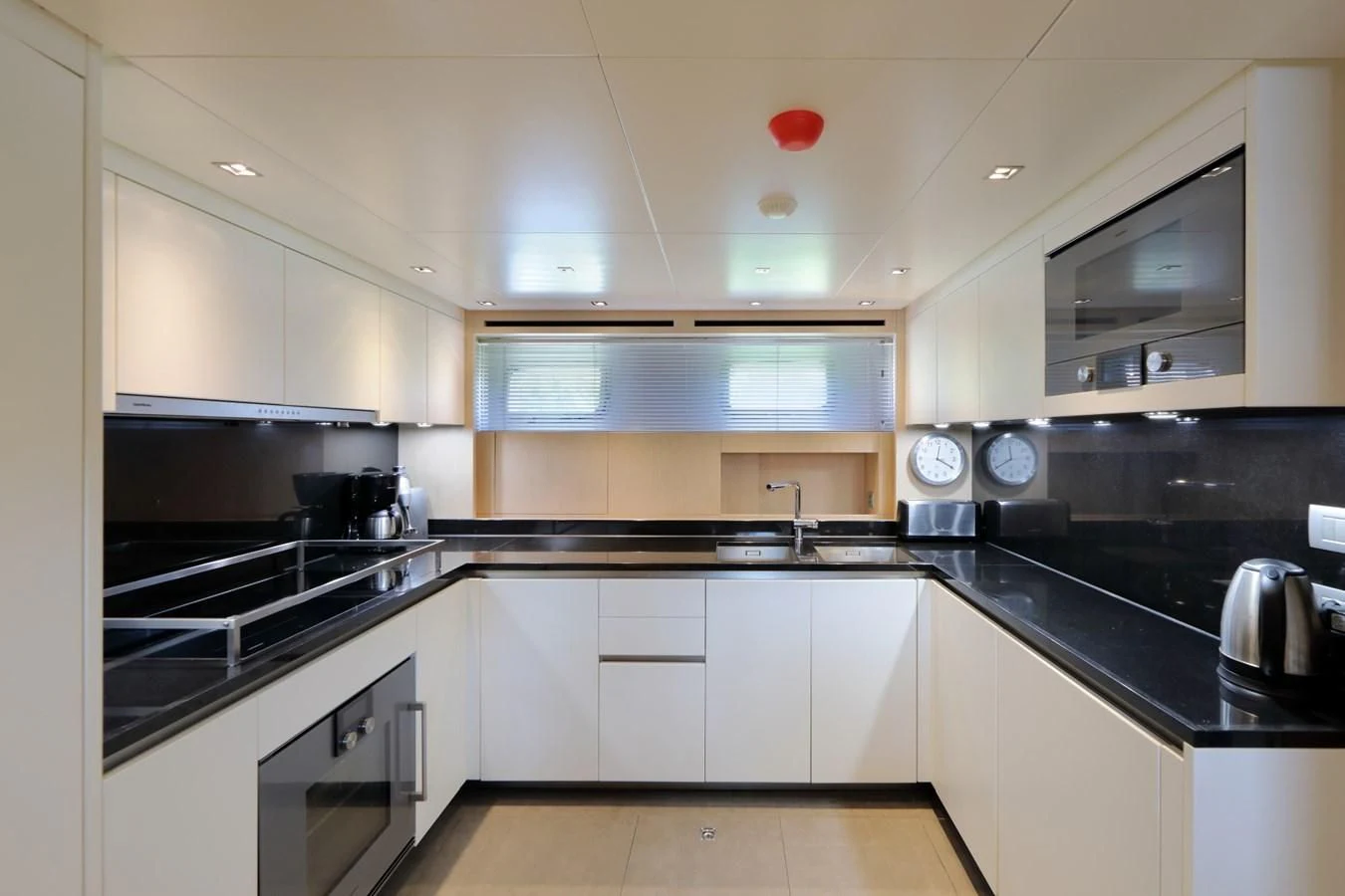 a kitchen with white cabinets aboard COBANA Yacht for Sale