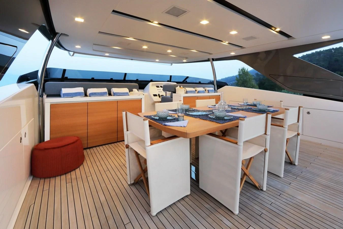 a kitchen with a table and chairs aboard COBANA Yacht for Sale