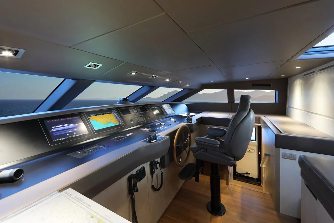 inside of a vehicle with a desk and chairs and a computer on the wall aboard COBANA Yacht for Sale