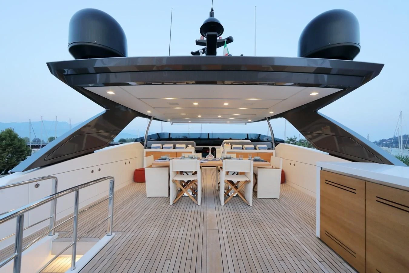 a large black helicopter on a wooden deck aboard COBANA Yacht for Sale
