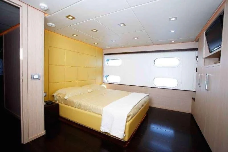 a room with a bed and a tv aboard ARIA Yacht for Sale