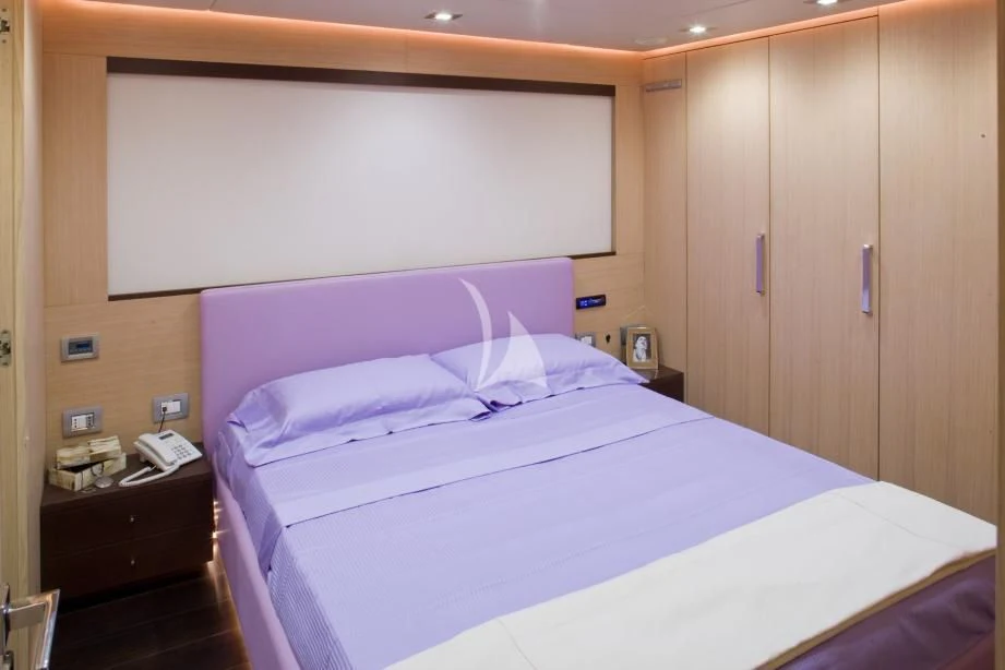 a bed with white sheets aboard ARIA Yacht for Sale