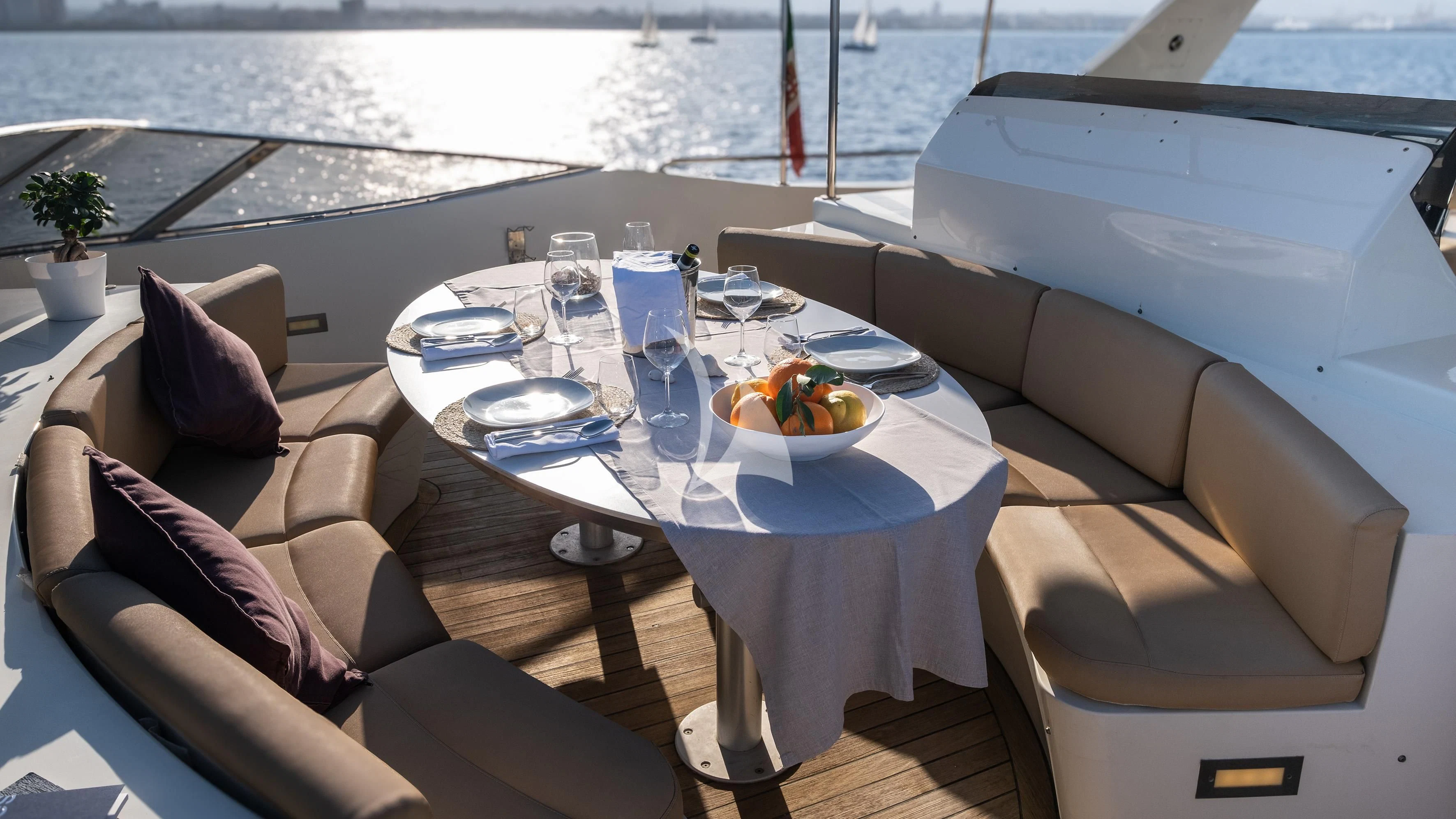 a table with chairs and a couch aboard ARIA Yacht for Sale
