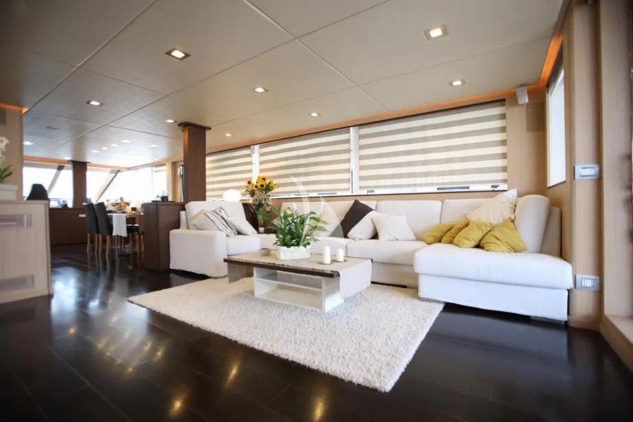 a living room with a couch and a table aboard ARIA Yacht for Sale