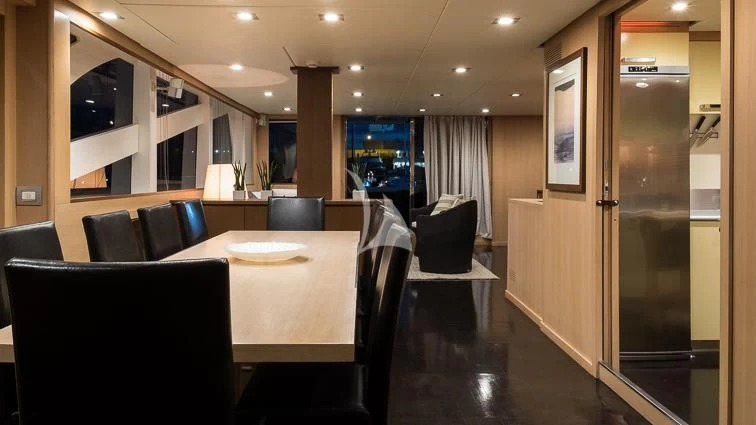 a conference room with a table and chairs aboard ARIA Yacht for Sale