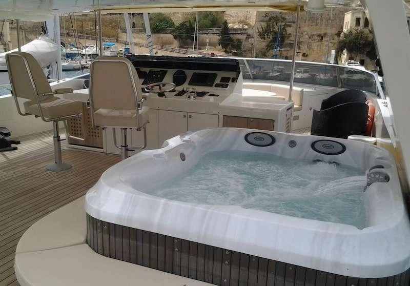 a large white table with chairs around it aboard ARIA Yacht for Sale
