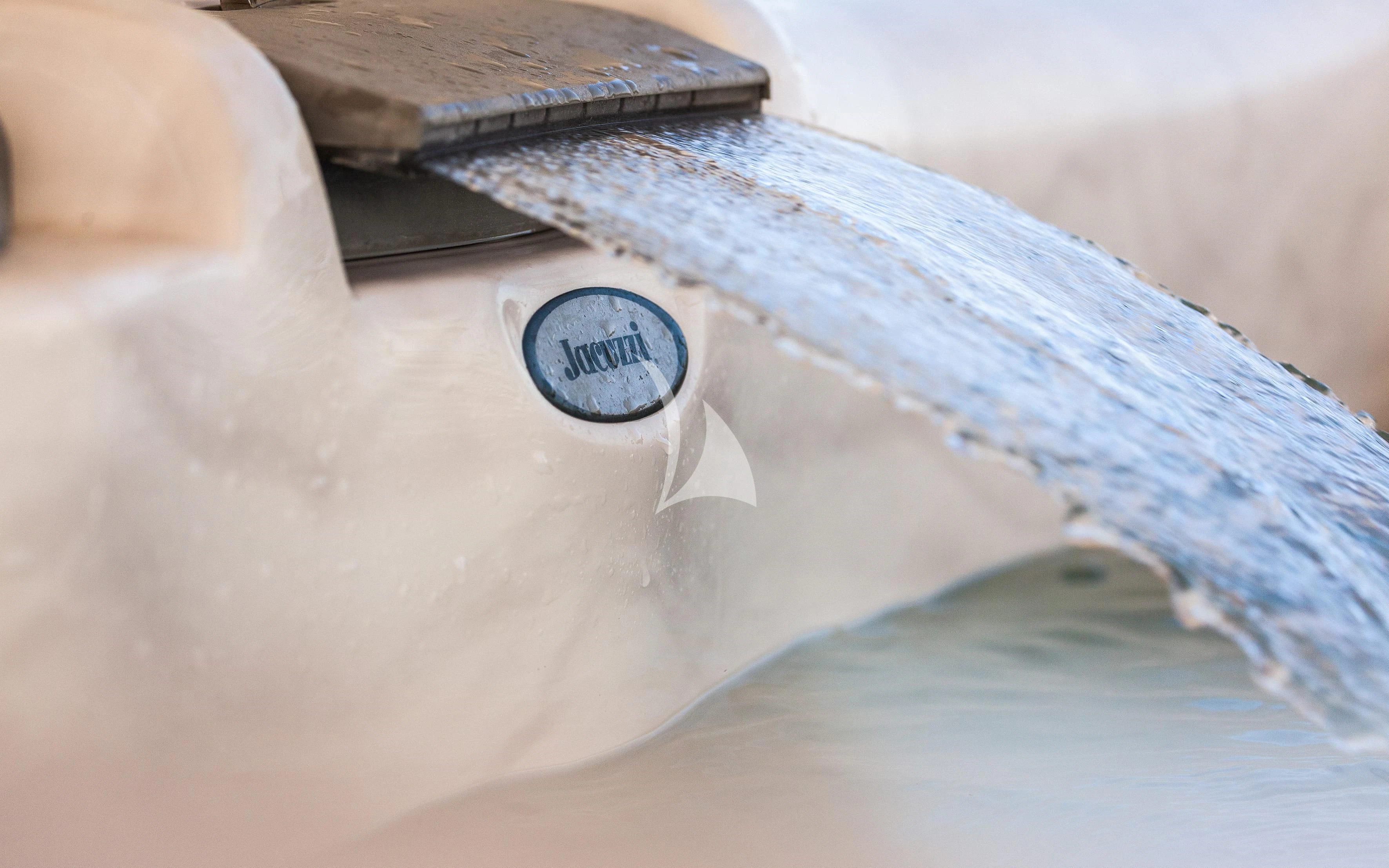 a close-up of a person's hand holding a pen aboard ARIA Yacht for Sale