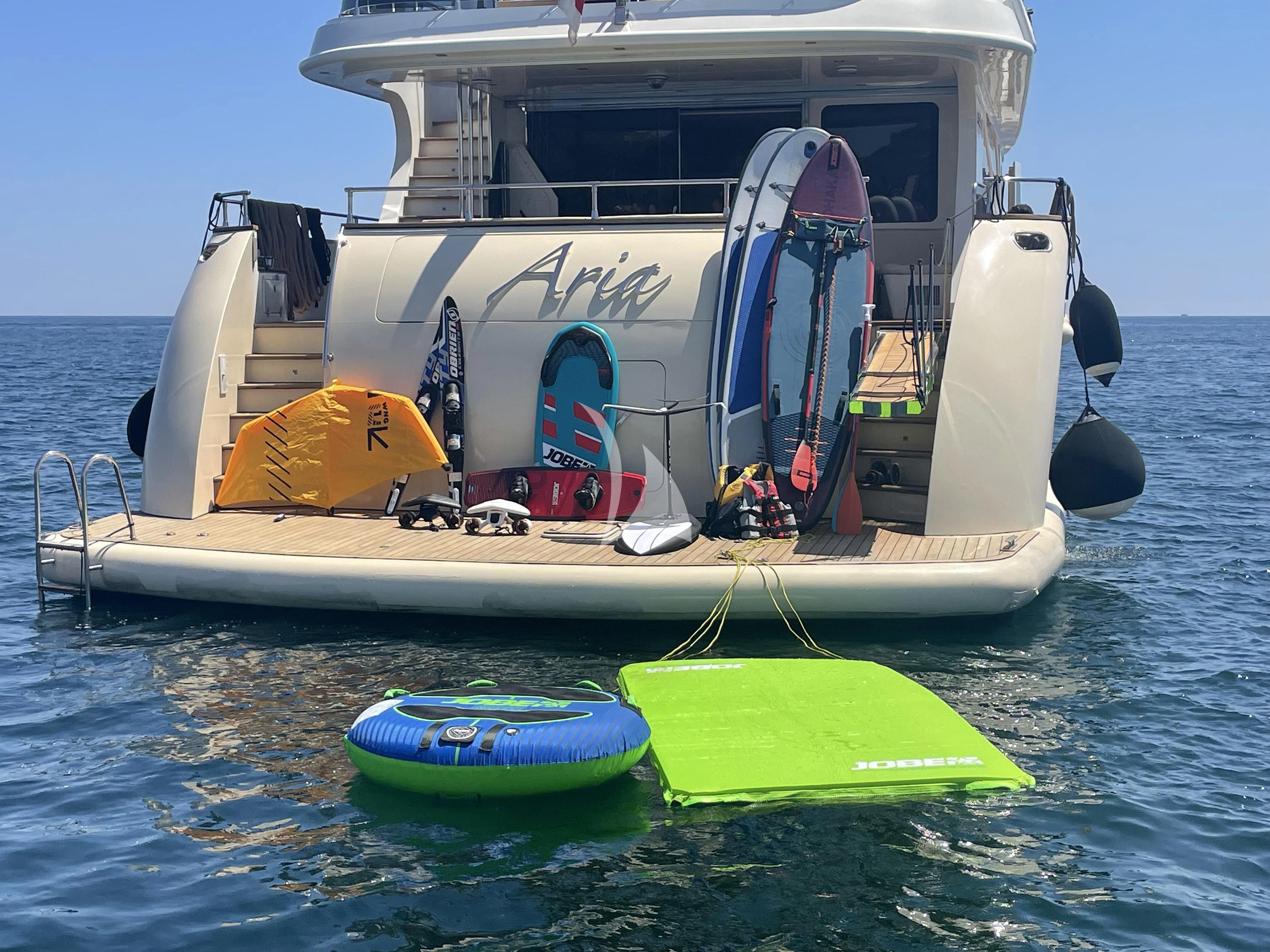 a boat with a surfboard on it aboard ARIA Yacht for Sale