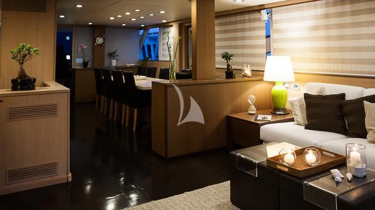 a room with a couch and a table and a lamp aboard ARIA Yacht for Sale