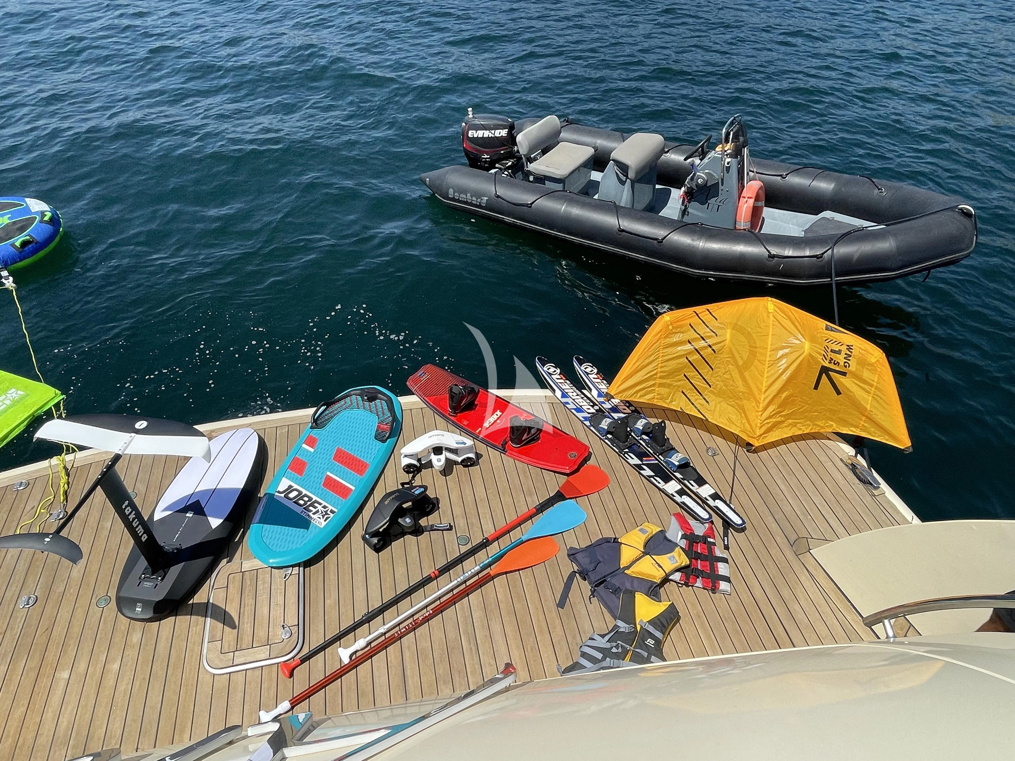 a boat with a yellow tent on it and a black boat on the water aboard ARIA Yacht for Sale