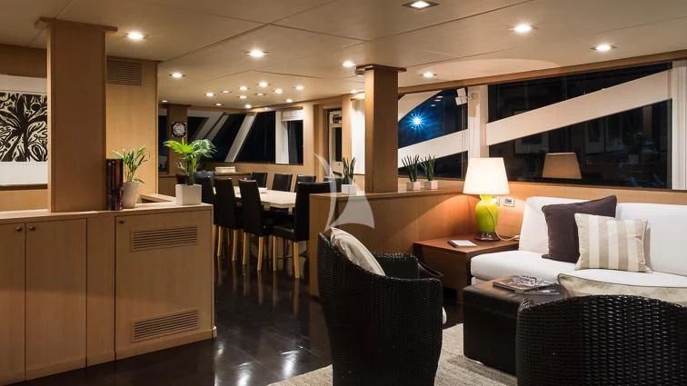 a room with a bed and a chair aboard ARIA Yacht for Sale