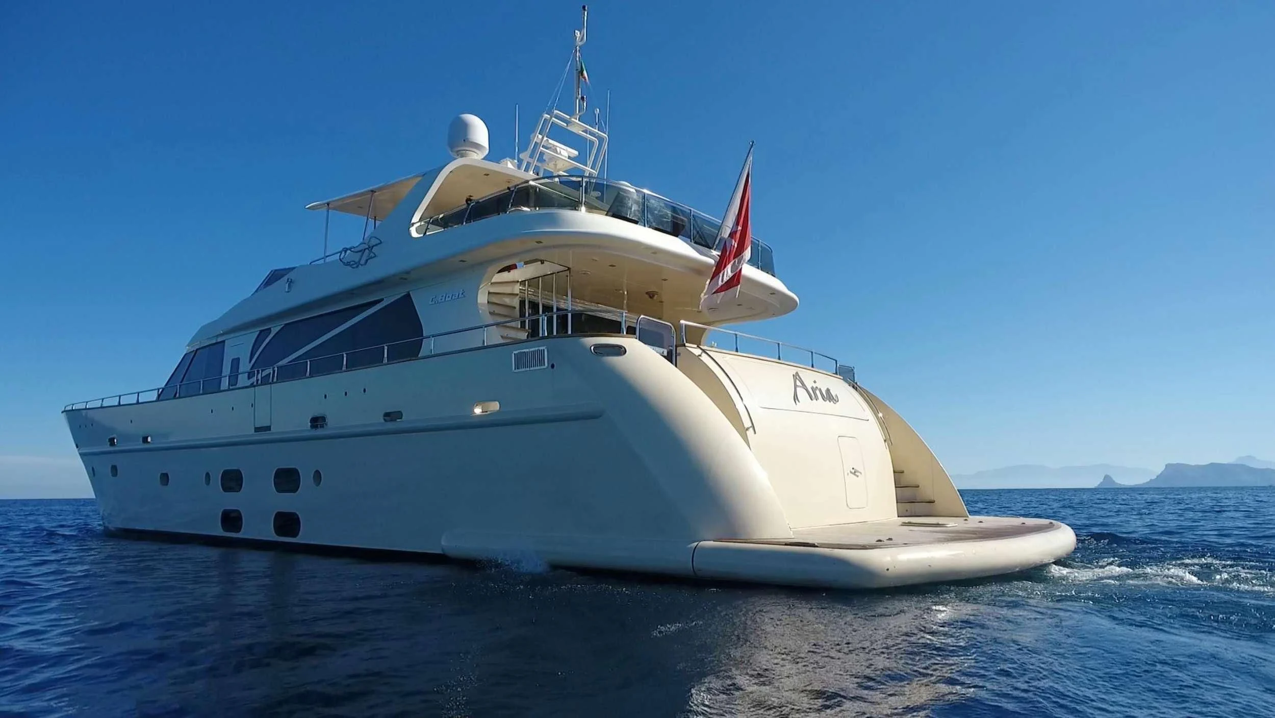 a large white boat in the water aboard ARIA Yacht for Sale
