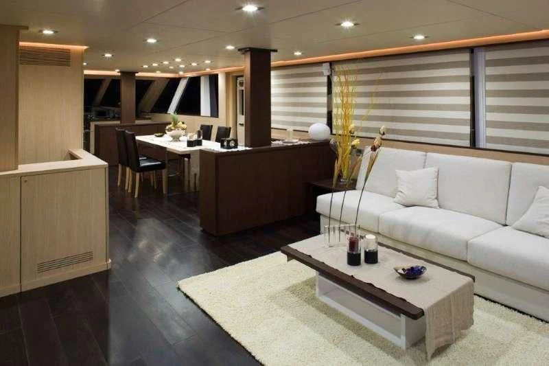 a room with a couch and a table aboard ARIA Yacht for Sale