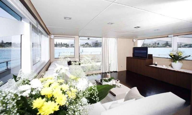 a room with a table and chairs aboard ARIA Yacht for Sale