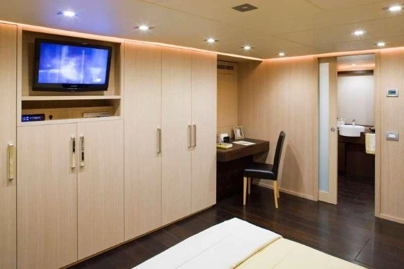 a room with a tv and a table aboard ARIA Yacht for Sale