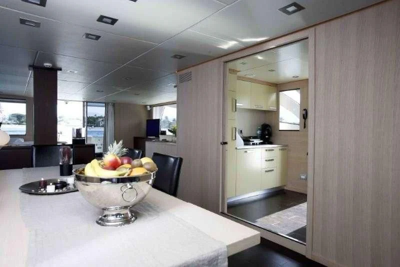 a kitchen with a bowl of fruit aboard ARIA Yacht for Sale