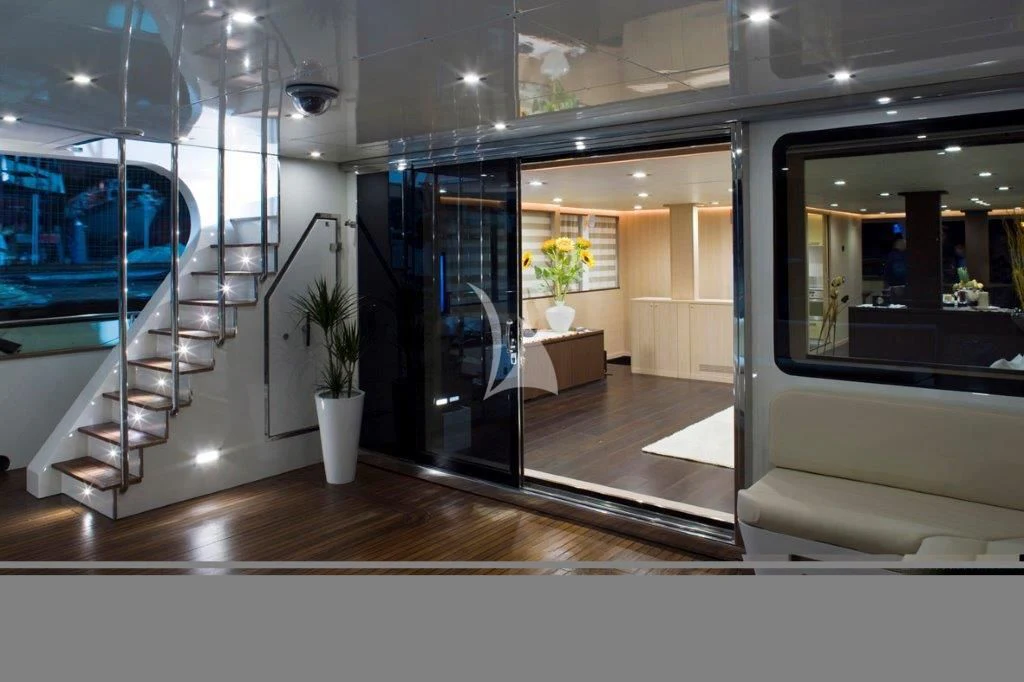 a room with glass walls and a staircase and a glass door aboard ARIA Yacht for Sale