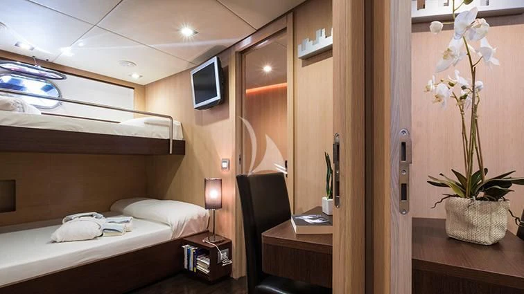 a room with a bed and a television aboard ARIA Yacht for Sale