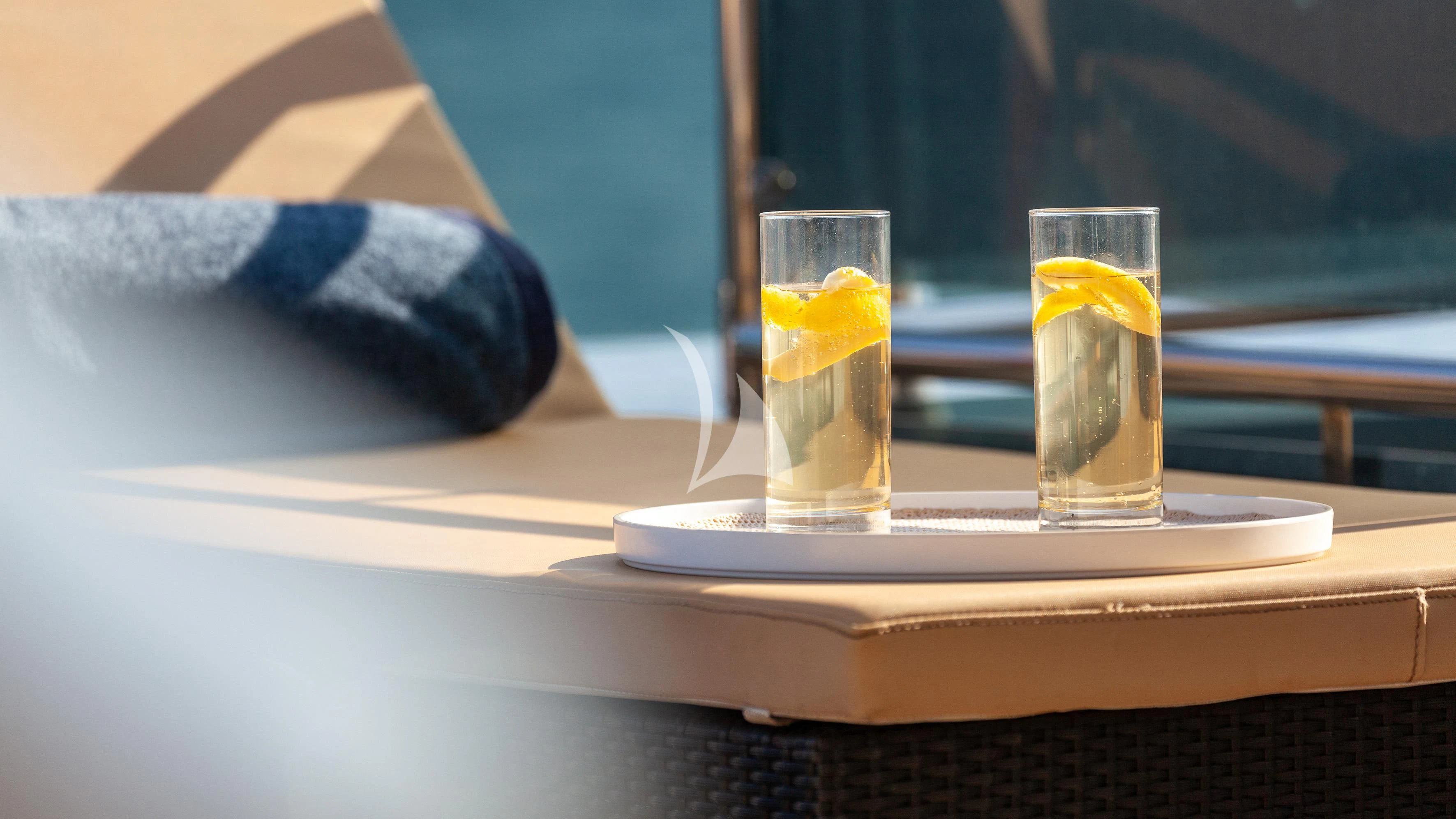 a glass of water on a tray aboard ARIA Yacht for Sale