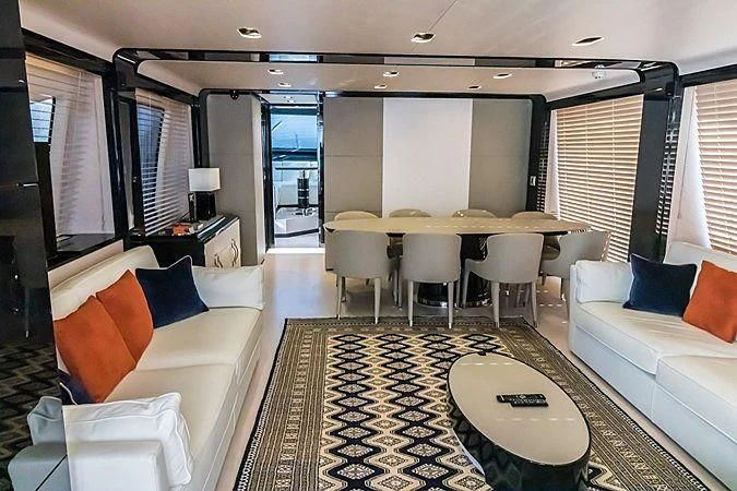 a living room with a large table and chairs aboard LENA Yacht for Sale