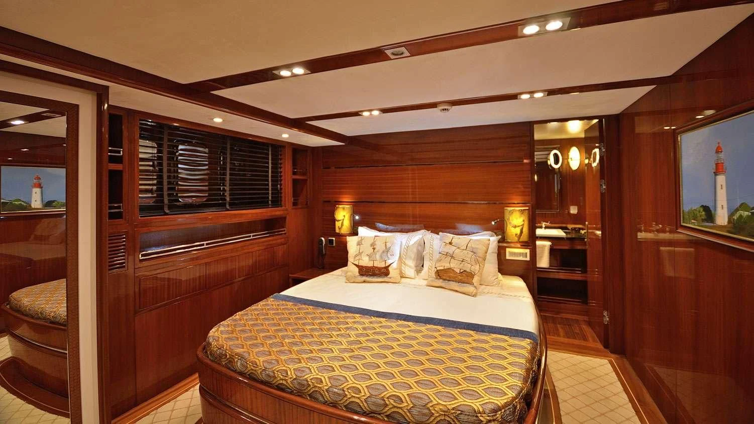 a bedroom with a bed and a mirror aboard G GIRL Yacht for Sale