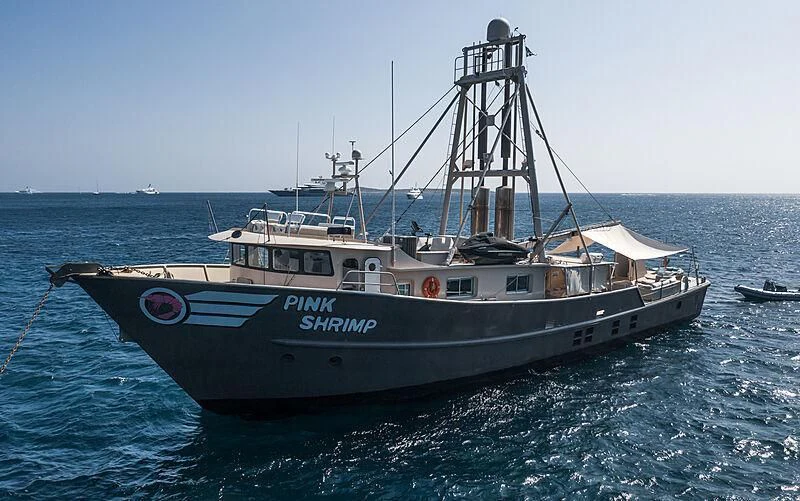 a large boat in the water aboard PINK SHRIMP Yacht for Sale