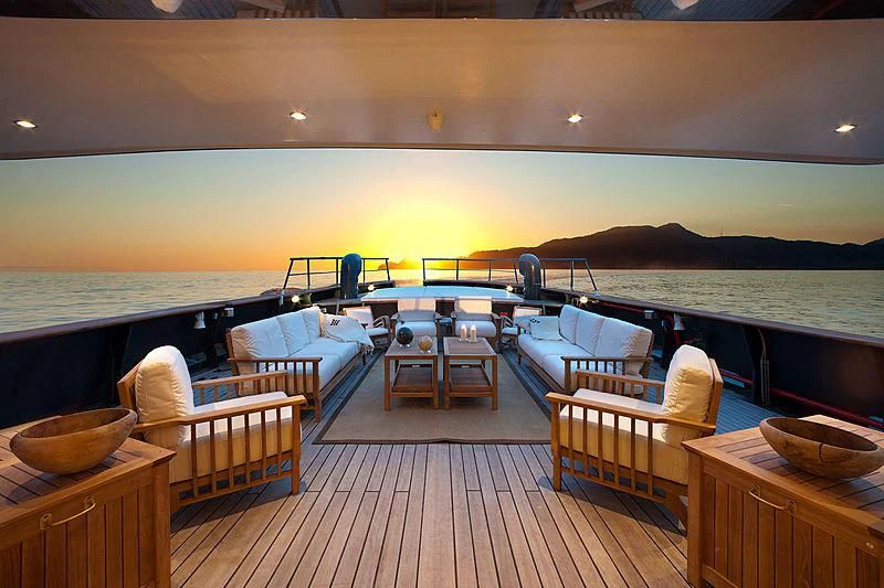 a room with a deck and chairs aboard VERVECE Yacht for Charter