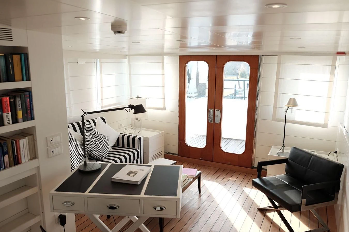 a room with a desk and a bed aboard VERVECE Yacht for Charter