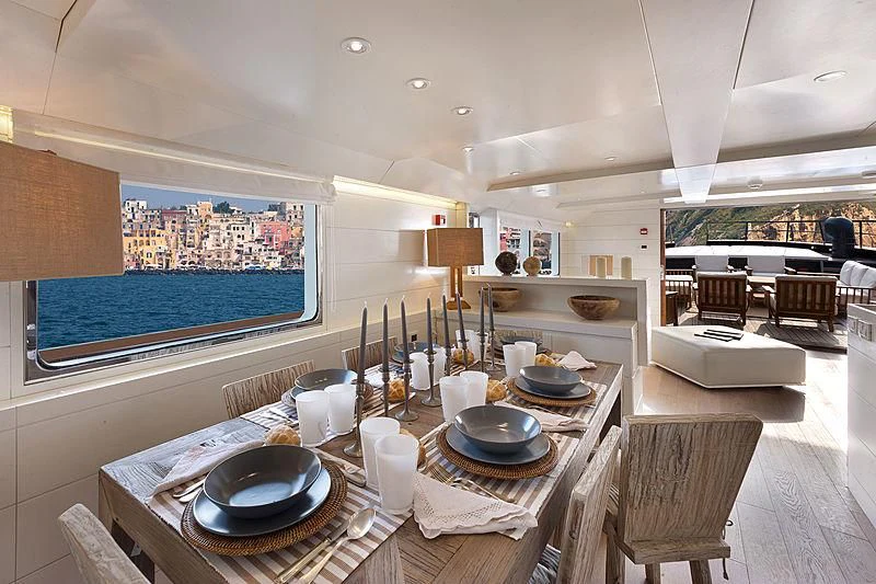a large room with a table and chairs aboard VERVECE Yacht for Charter