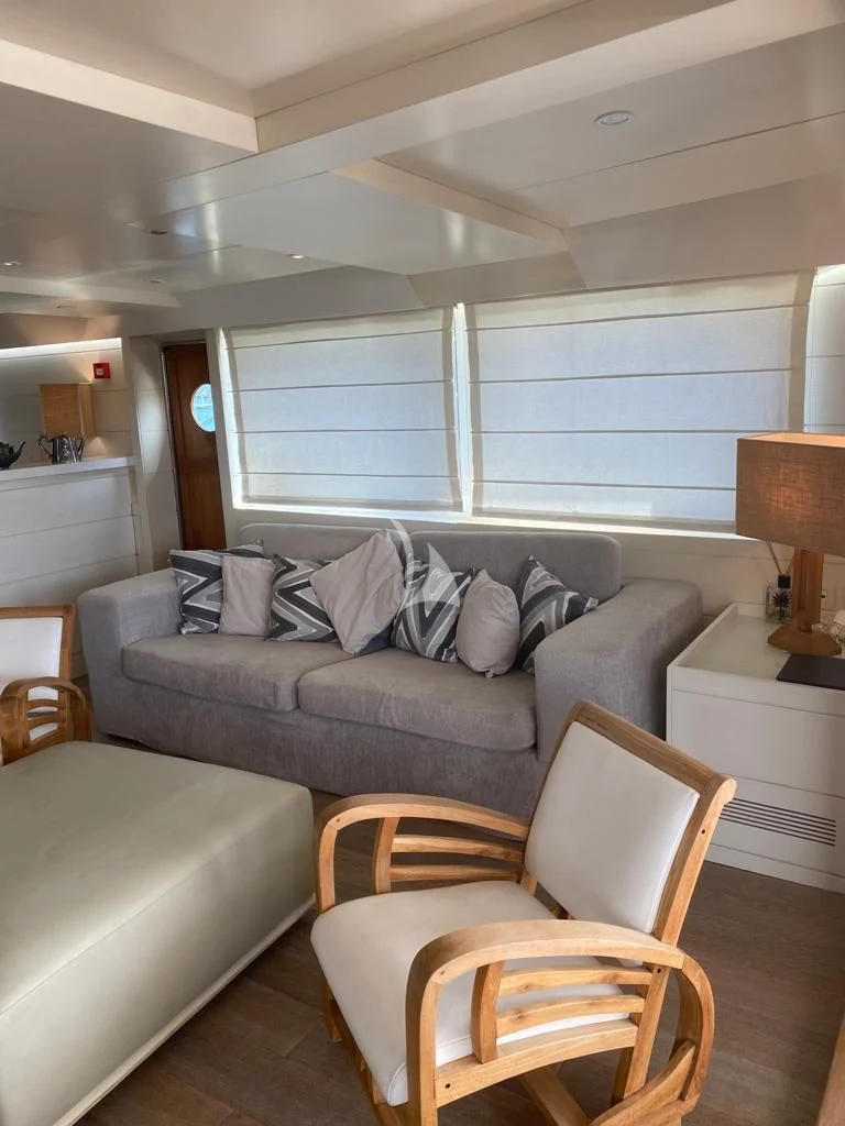 a living room with a couch and a window aboard VERVECE Yacht for Charter