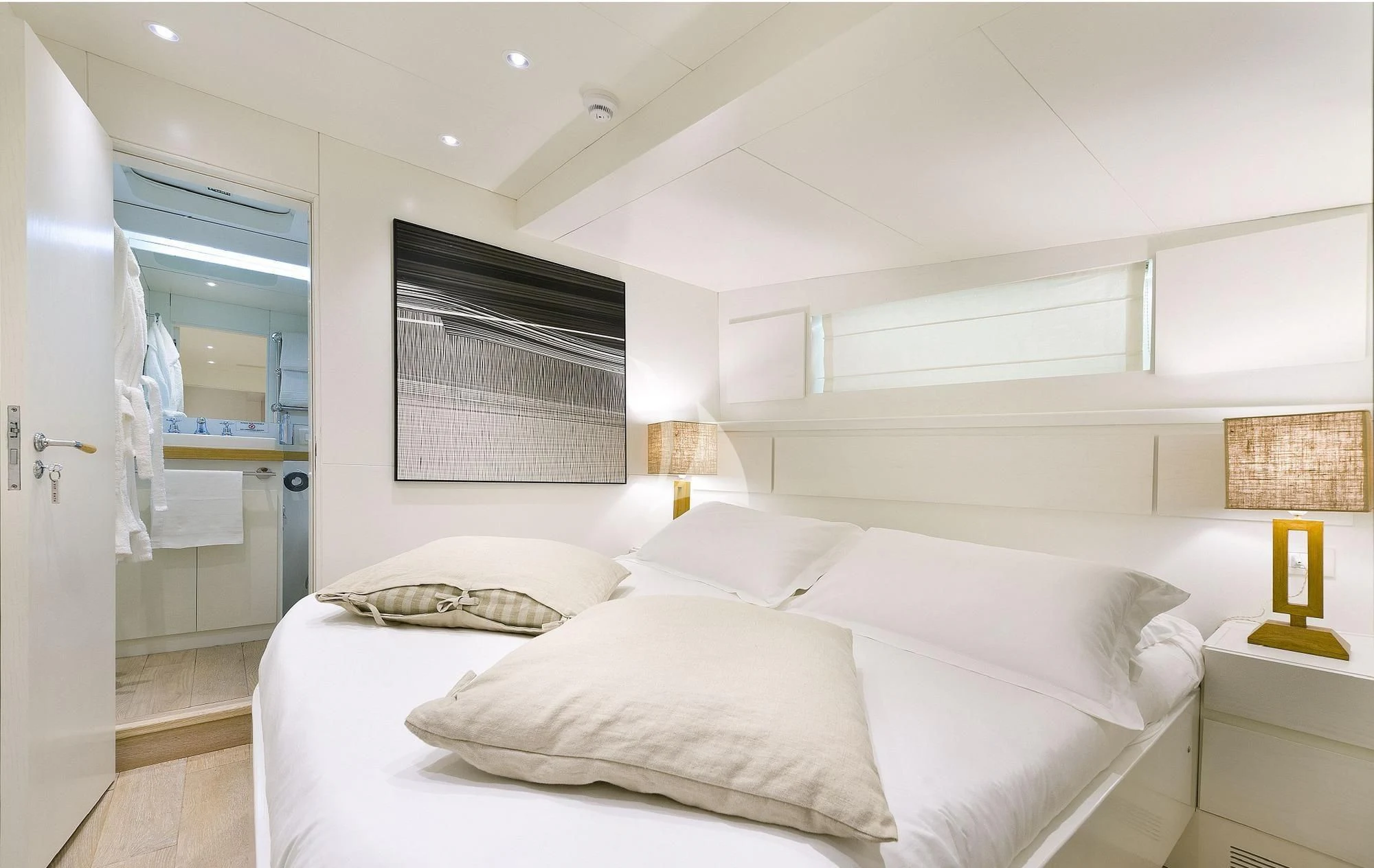 a bedroom with a bed and a lamp aboard VERVECE Yacht for Charter