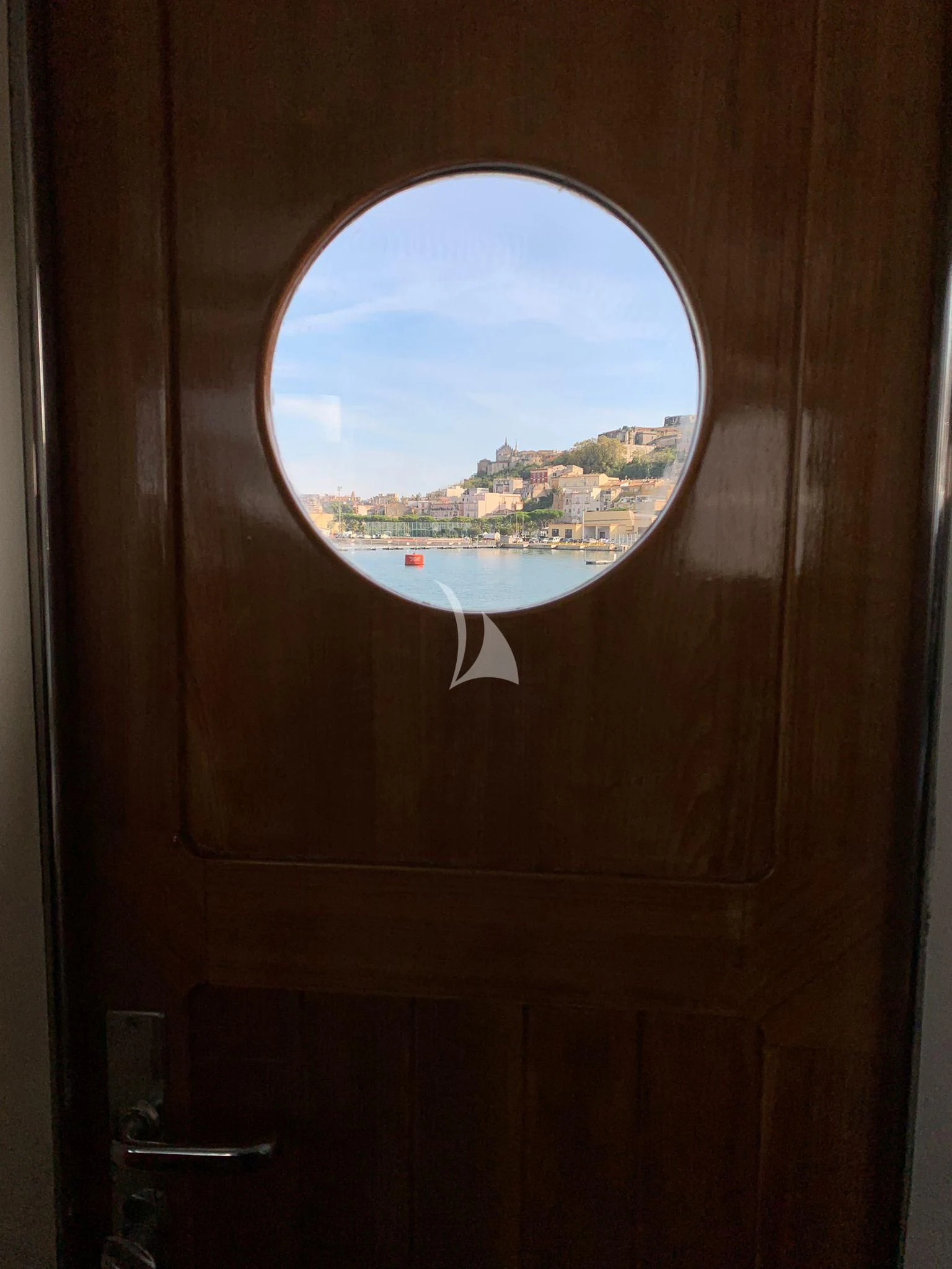a window with a view of a city below aboard VERVECE Yacht for Charter