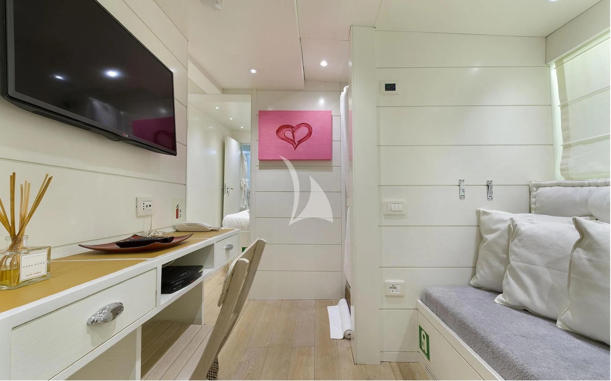 a room with a bed and a desk aboard VERVECE Yacht for Charter