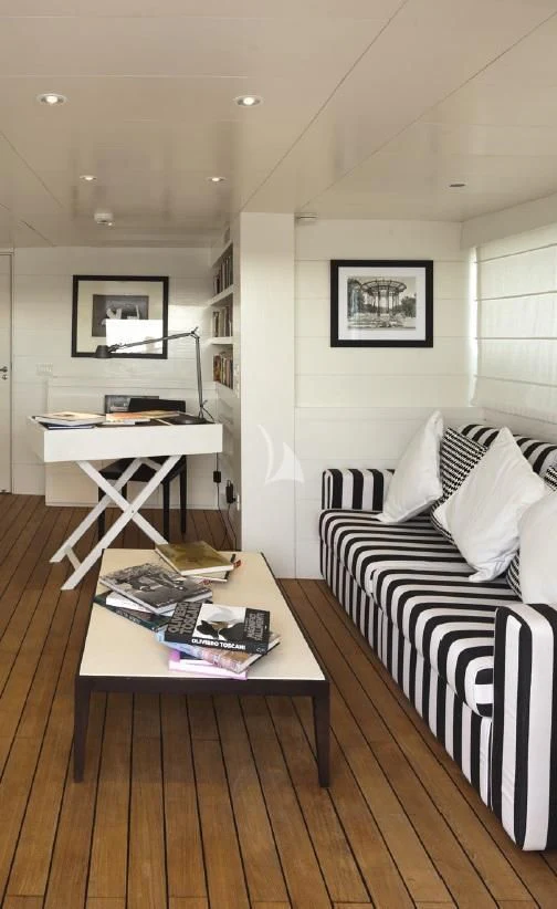 a living room with a couch and a coffee table aboard VERVECE Yacht for Charter